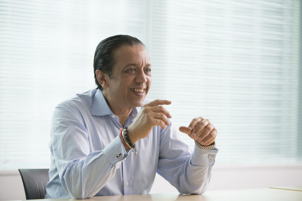 Misra Rajeev sitting at a desk