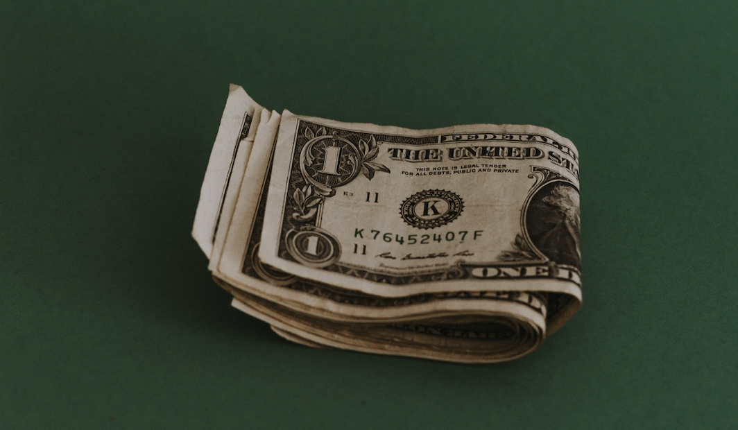 Dollar bills on green background