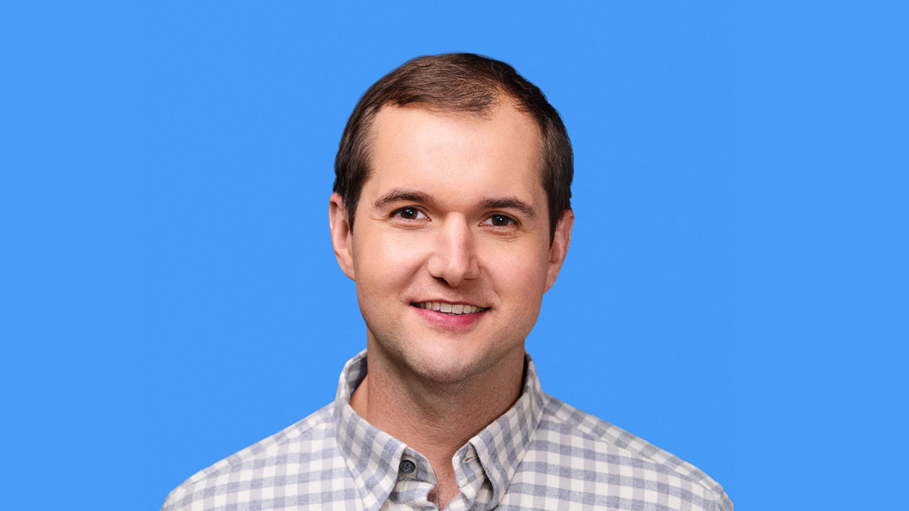 Ben Robbins headshot against blue background