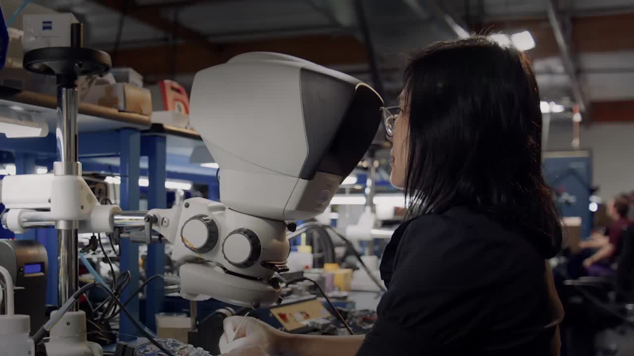 Woman looking through microscope