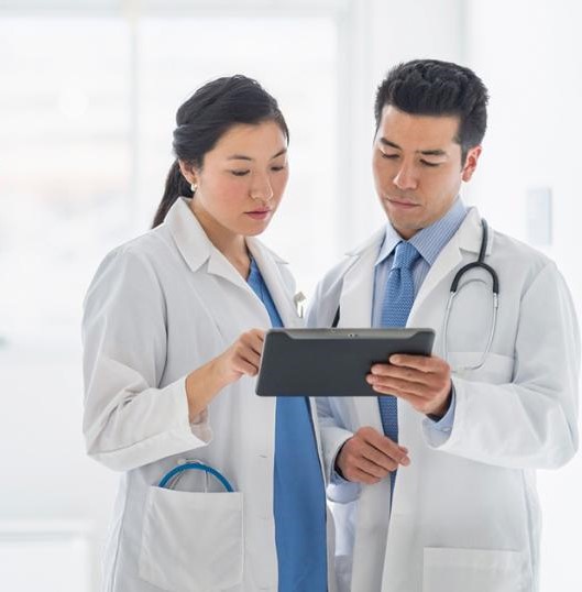 Two physicians looking at a tablet