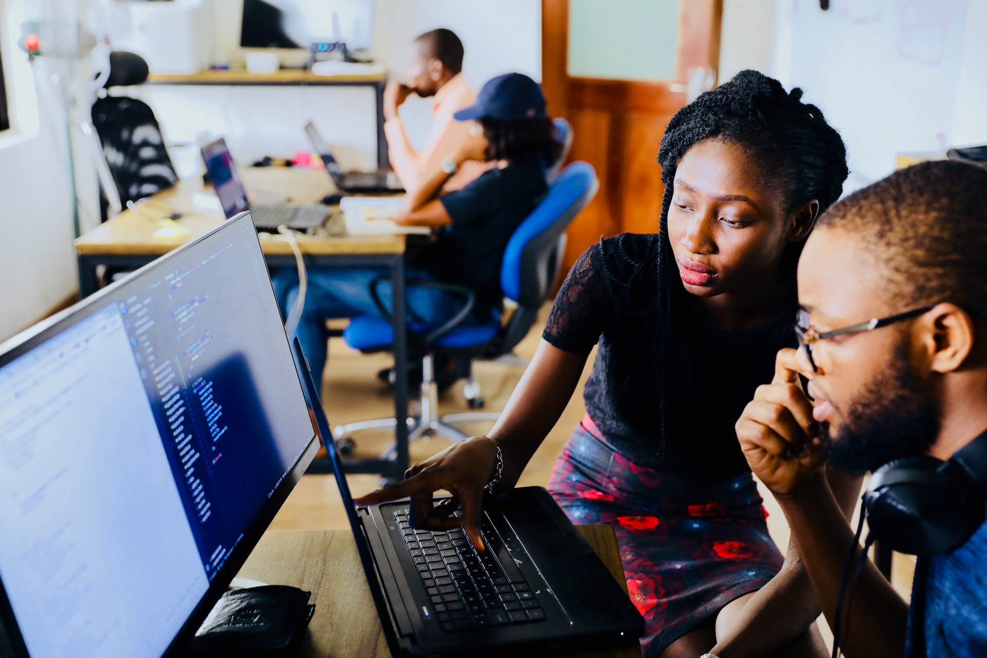 Workers collaborating on computer