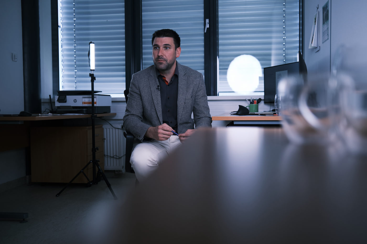 Vojtěch Helikar sitting in his office, talking to an interviewer who is out of frame.