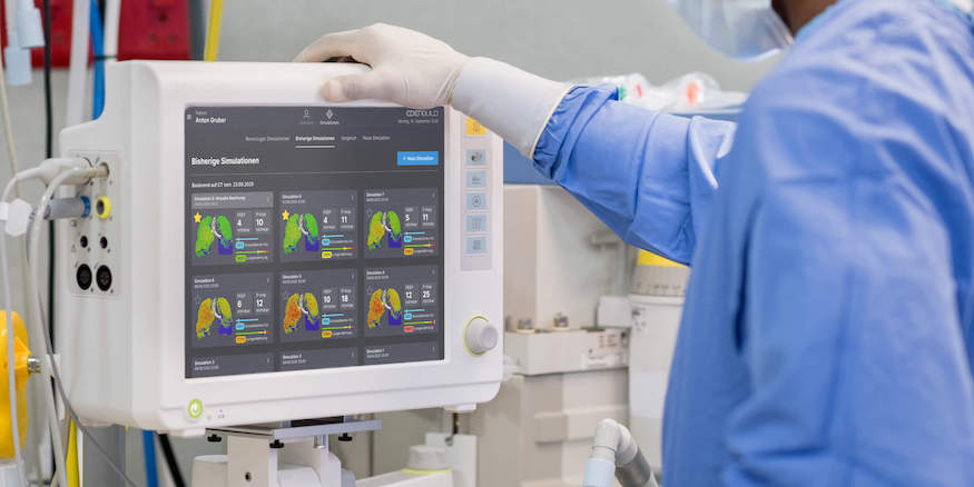 a nurse has her hand on a monitor showing Ebenbuild's interface