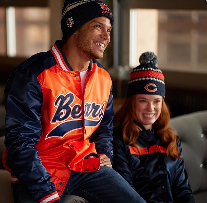 Male and female Chicago Bears fans sitting in team apparel
