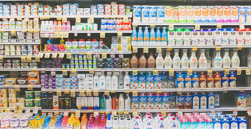 supermarket shelves filled with dairy and alternative milk products