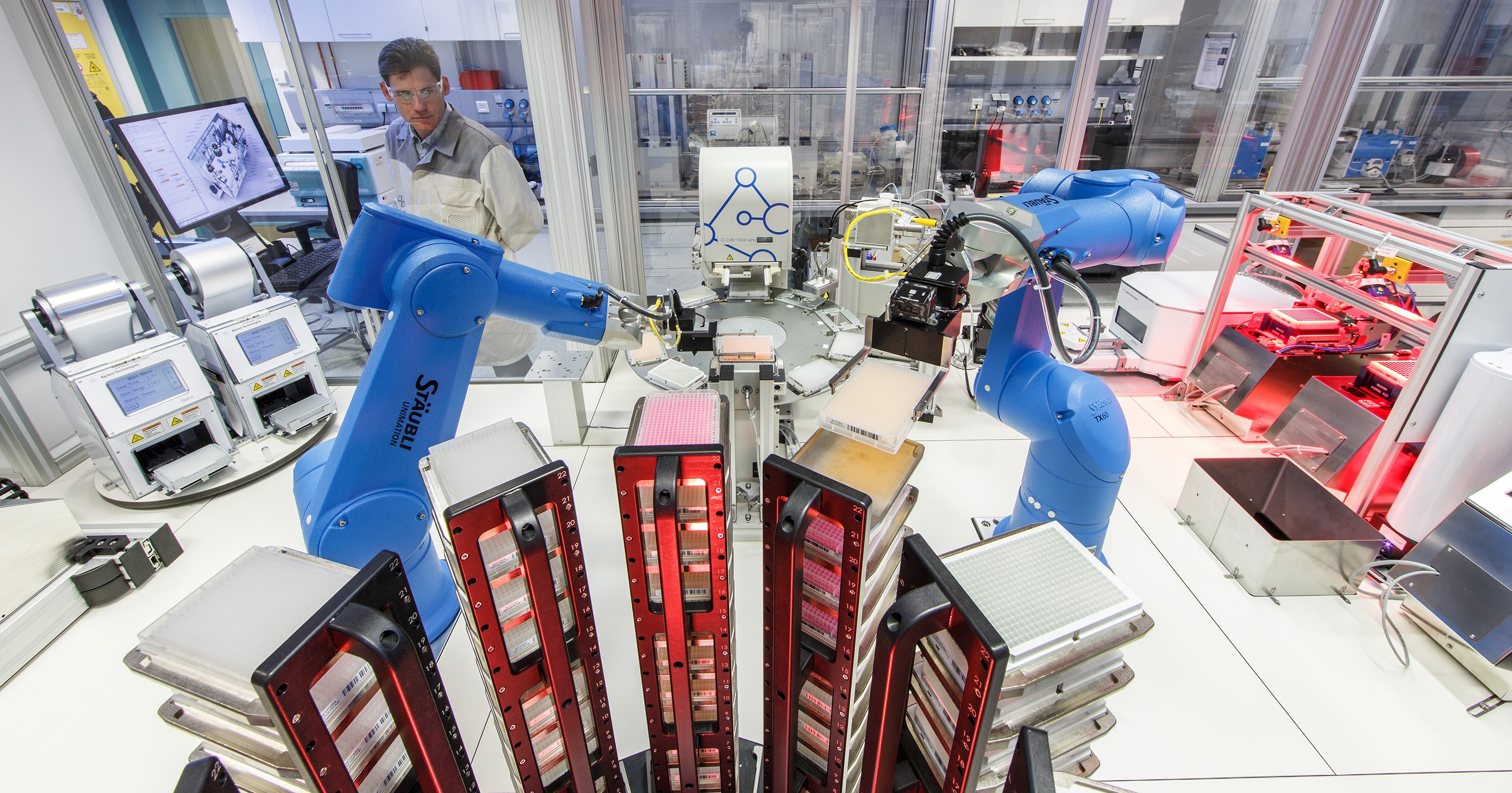 Robots analyze and sort samples under the supervision of a Bayer employee