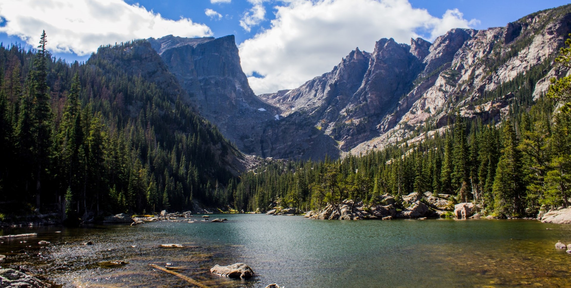 A stream leading to picturesque mountains and forest