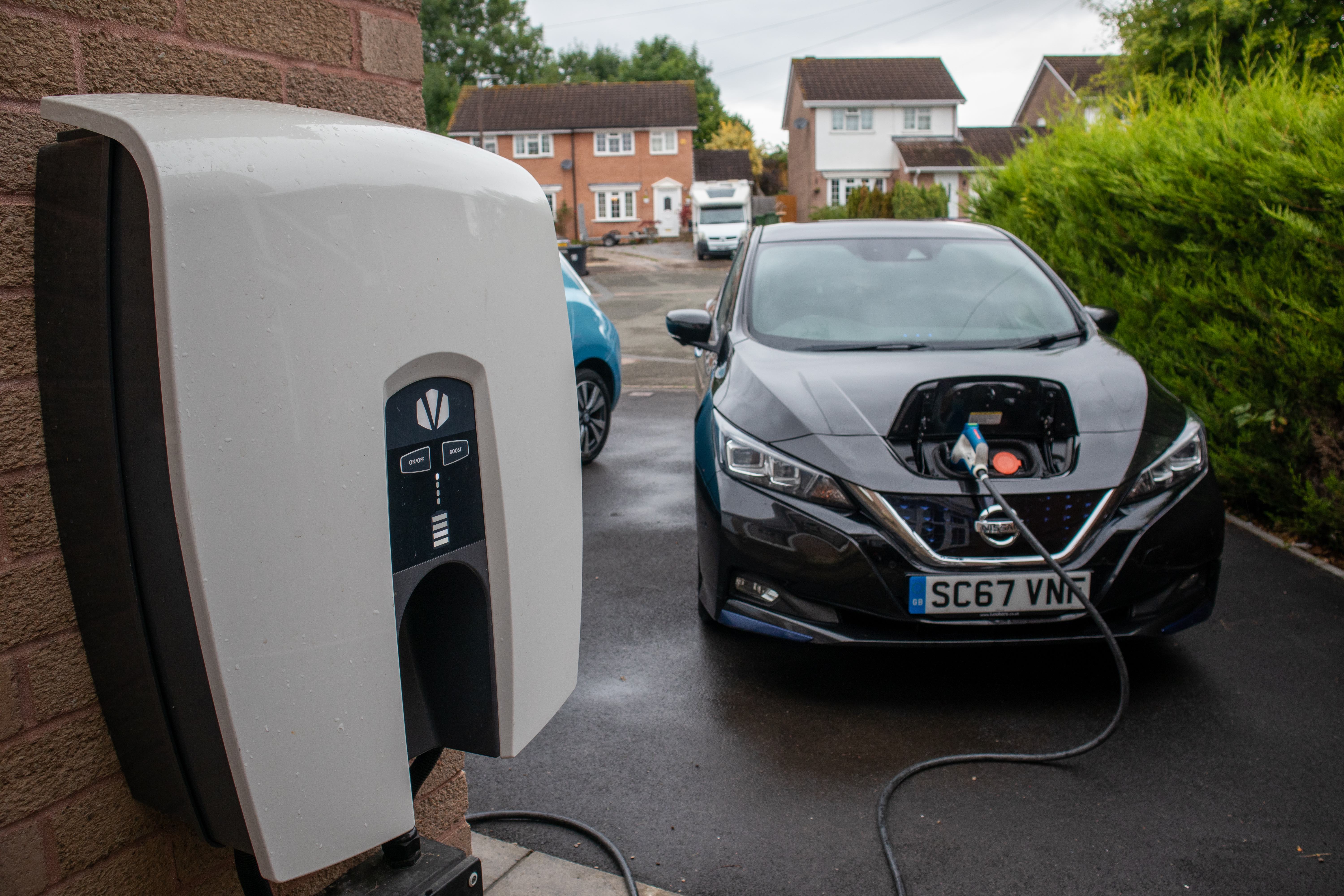 Car charging with Indra charger outside houses