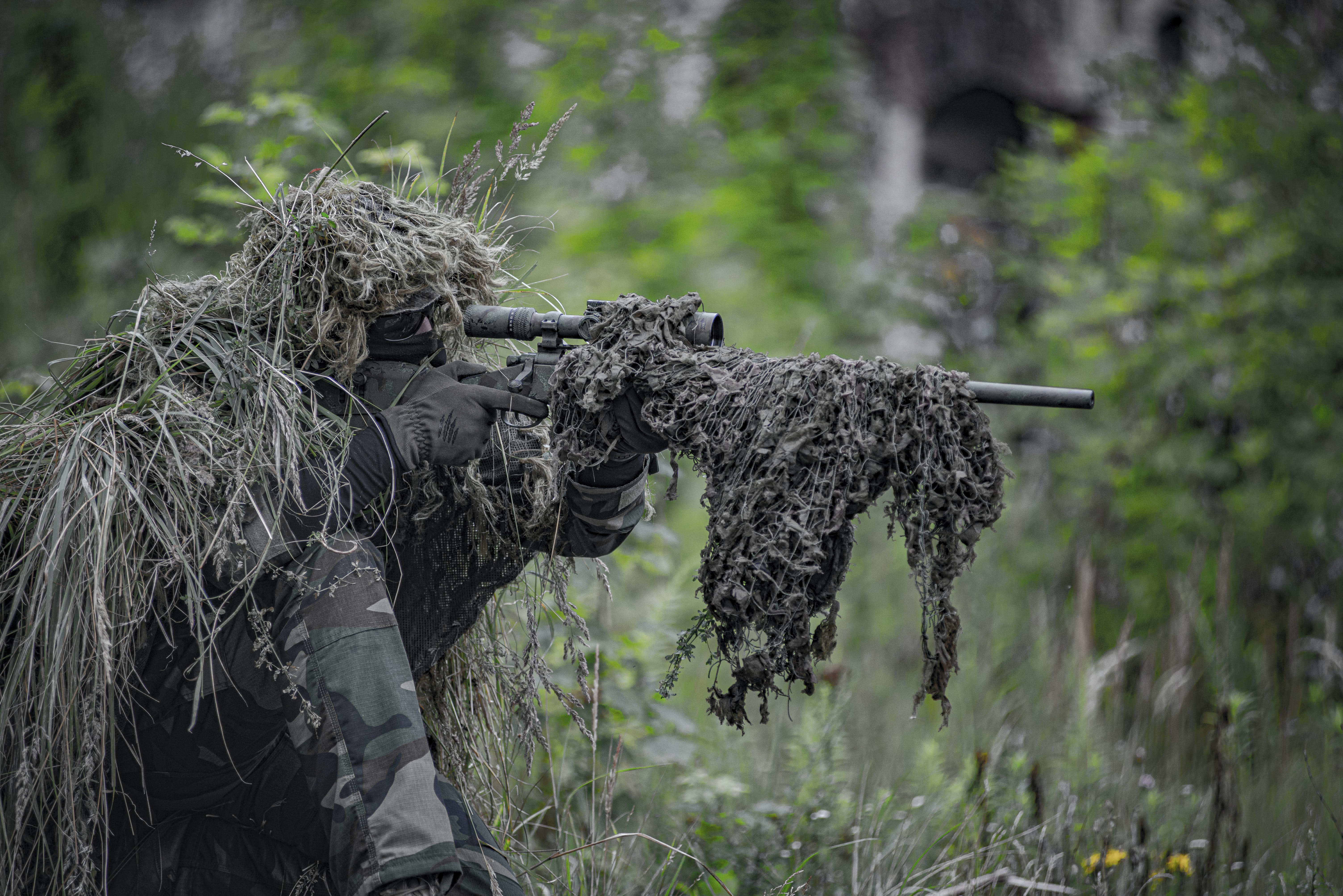 Camouflaged soldier with rifle
