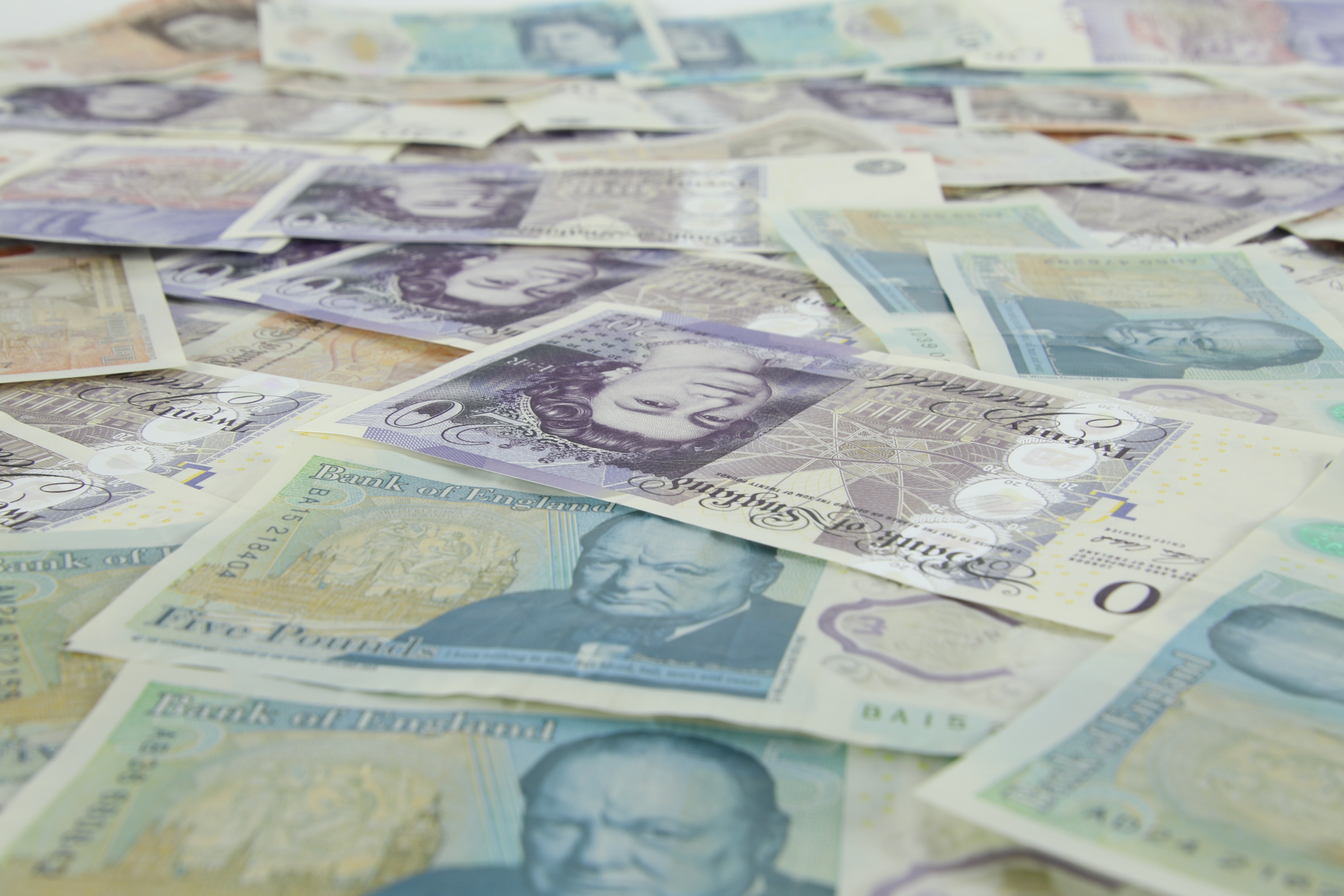 British bank notes spread out over a table