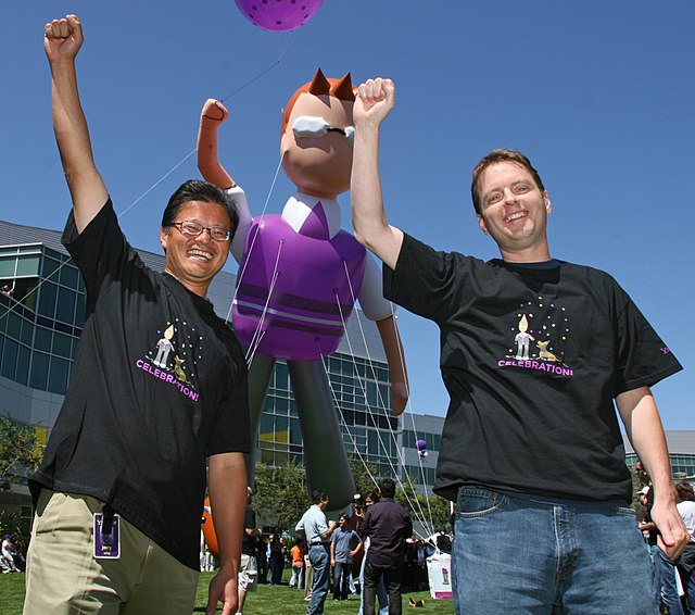 Yang and David Filo posing in front of an inflatable balloon character, circa. 2007