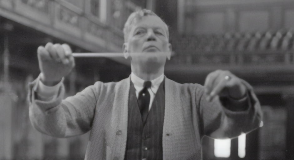Black and white photo of an orchestra conductor