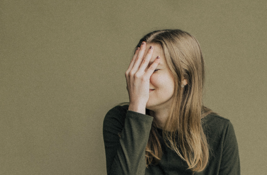 woman with hand over her face