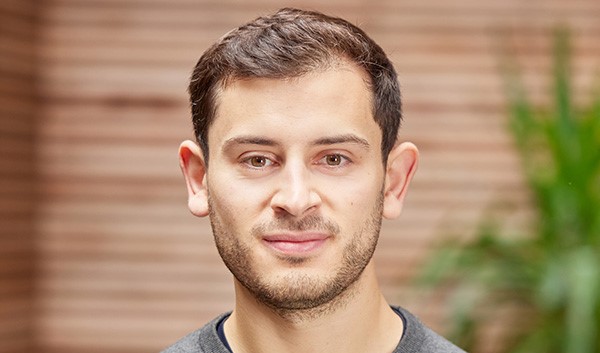 Headshot of Louis Fearn in front of wood fence