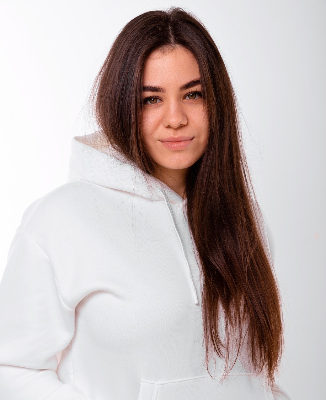 Daria Yaniieva in white hoodie in front of white background
