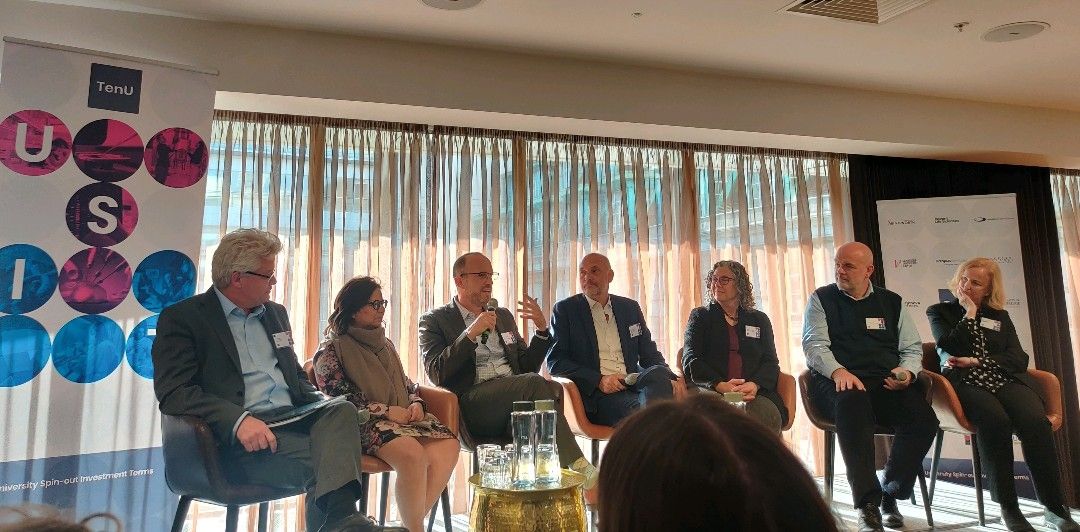 members of TenU's USIT Guide working group sit on stage, from left to right: Andy Neely, Maina Bhaman, Orin Herskowitz, Jim Wilkinson, Karin Immergluck, George Baxter and Anne Lane