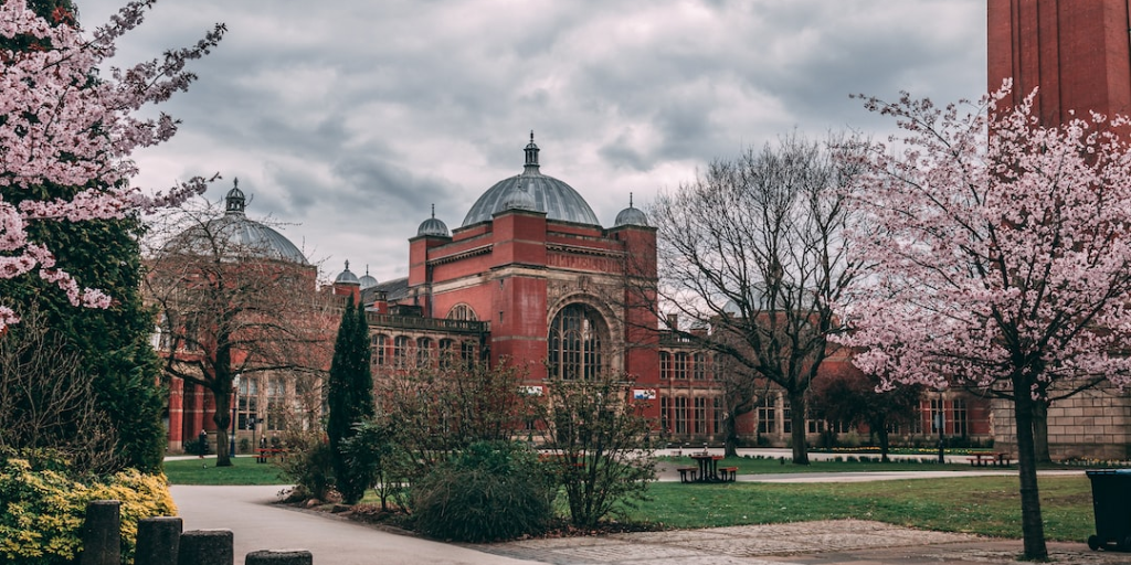 University of Birmingham's Aston Webb Building, a red-brick building with a glass dome ceiling housing the student support services