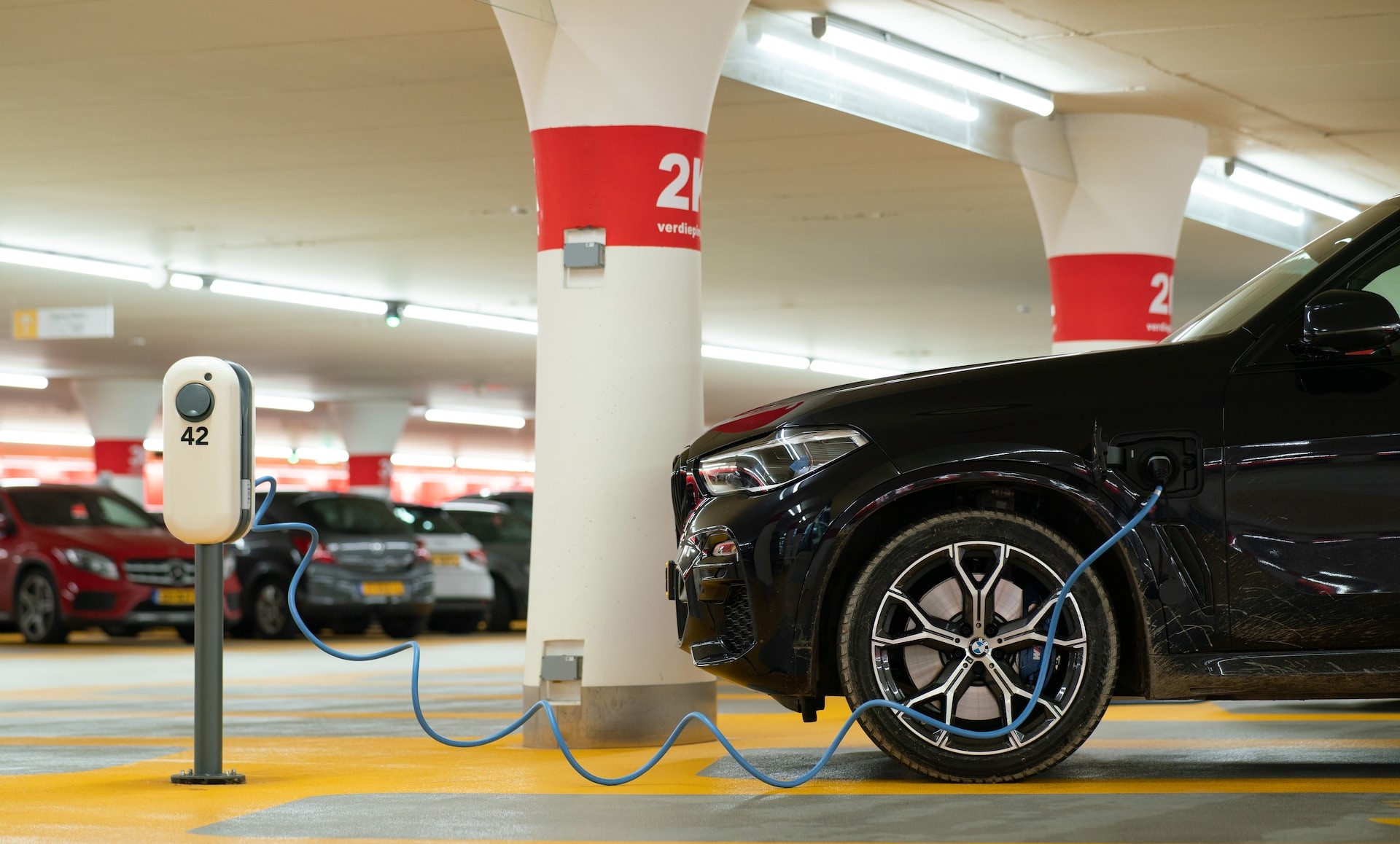 Black car charging in underground car park