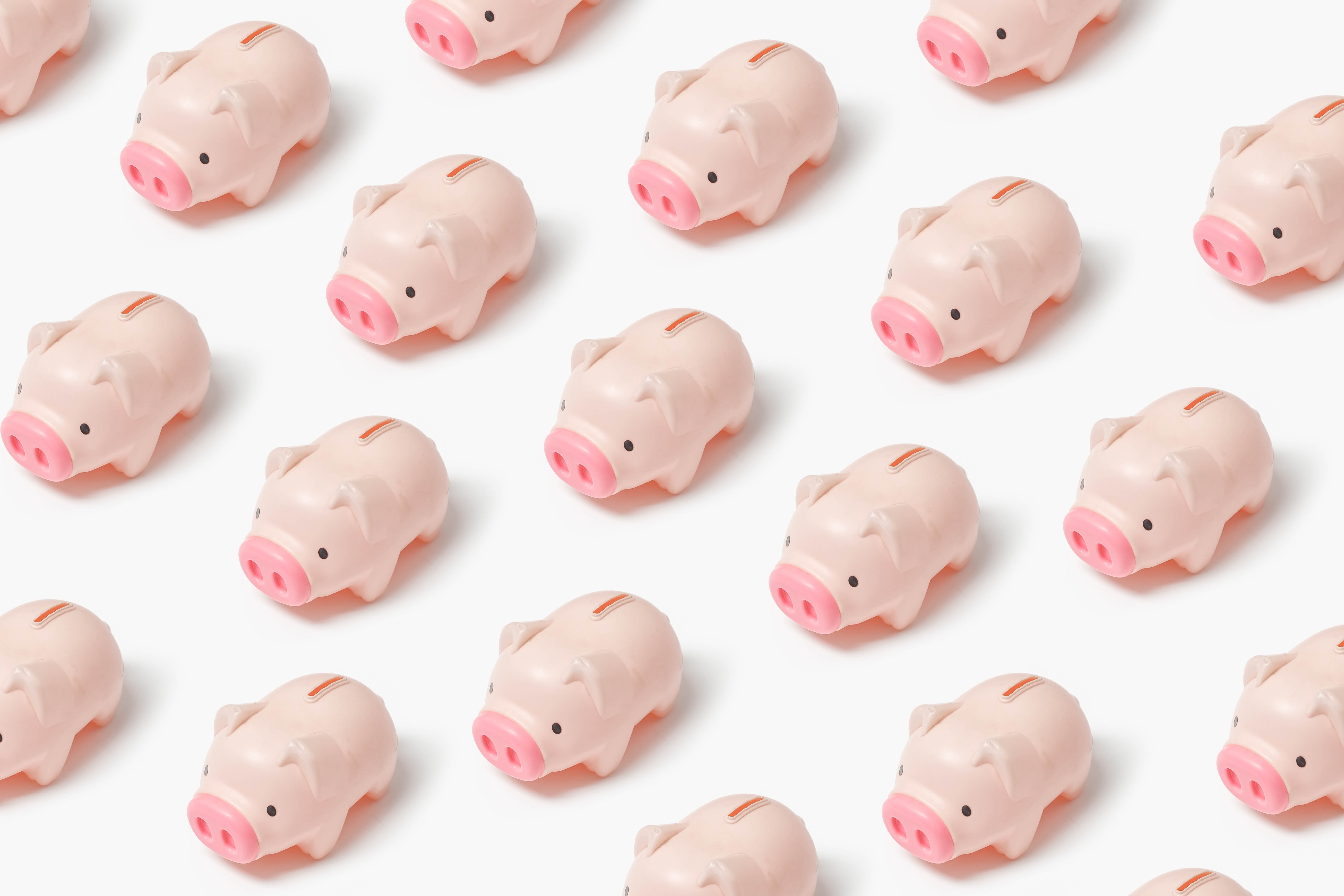 Many pink piggy banks lines up in a grid