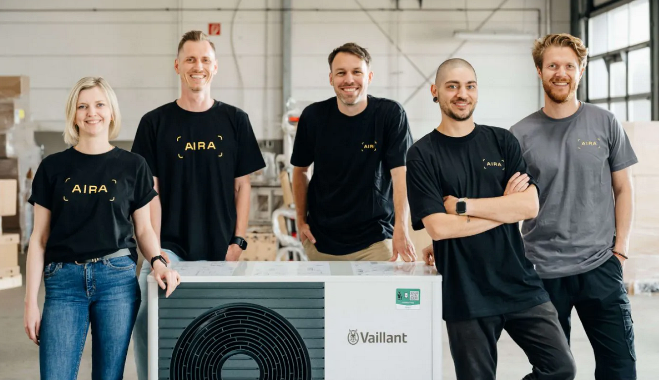 Five Aira employees standing in front of a heat pump