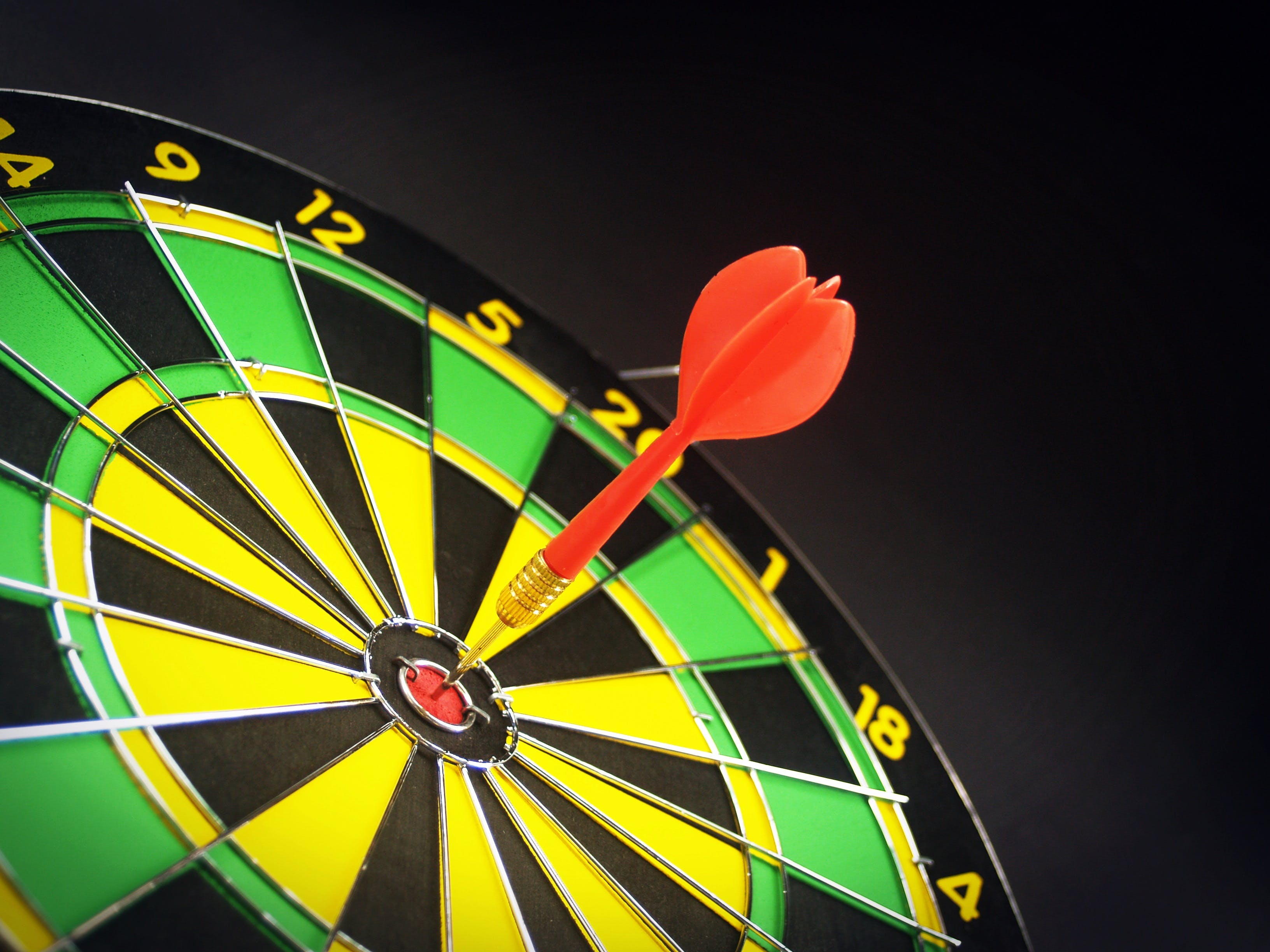 a dart hitting bullseye on a dart board