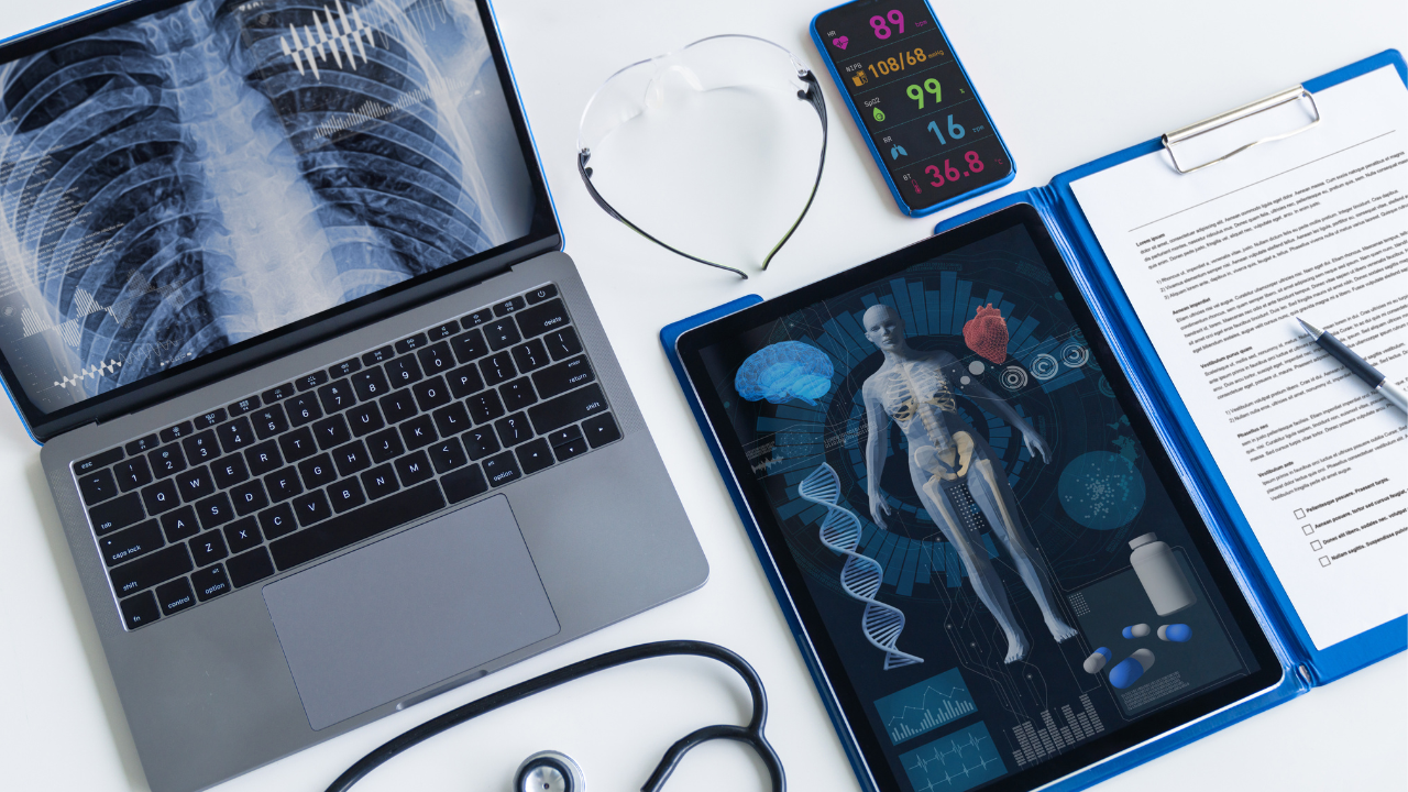 Laptop and phone with medical images with stethoscopes next to them