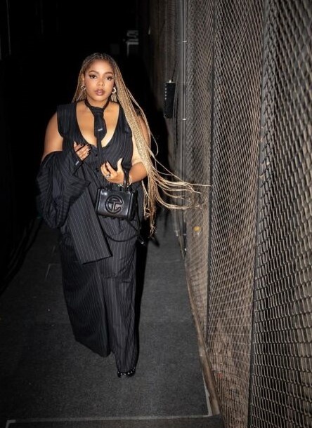 Shekhina walking by a fence at night