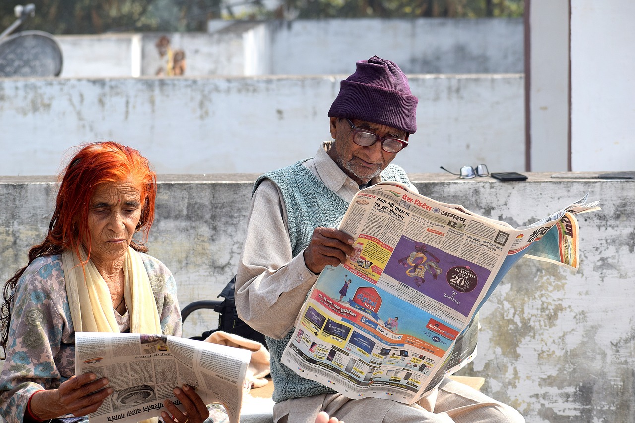 Old couple reading the newspaper