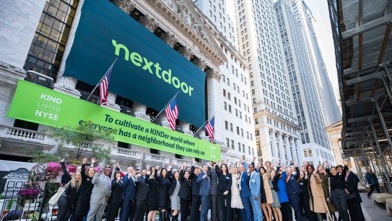 Nextdoor staff below a huge street ad celebrating their NYSE listing