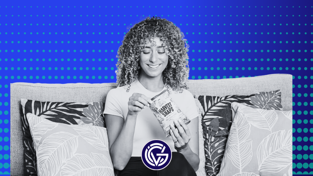 A woman eating a snack on a couch in black and white, against a GCV news template