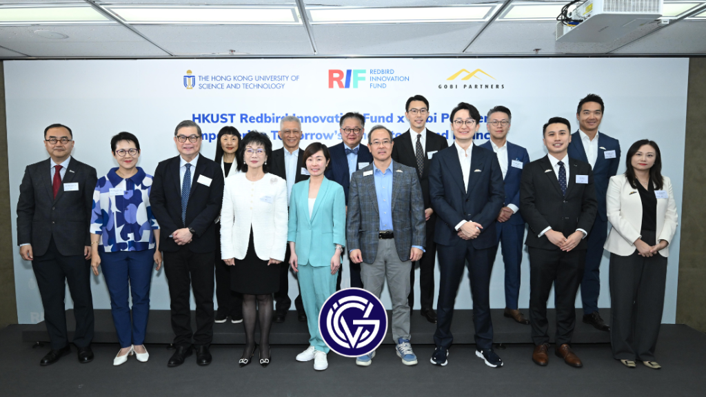 The founders of Gobi-Redbird Innovation Fund posing in front of a sign