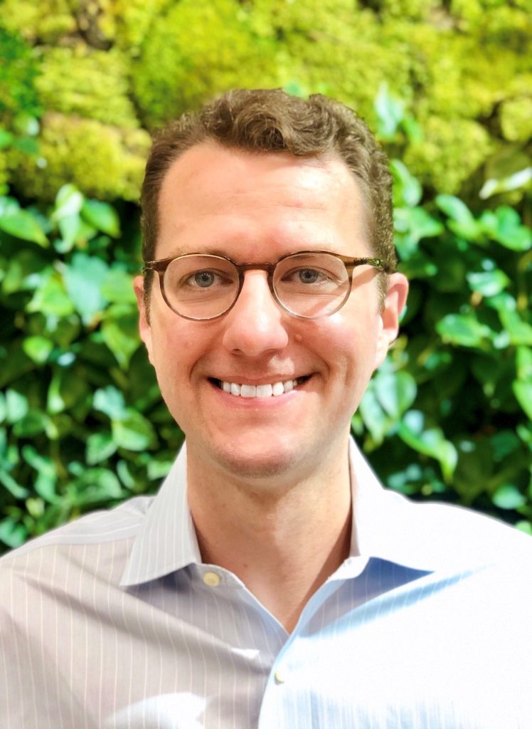 Mark Brooks, in front of a bush