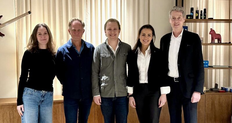 Members of Aggregate Media and Collaxio's boards posing with each other